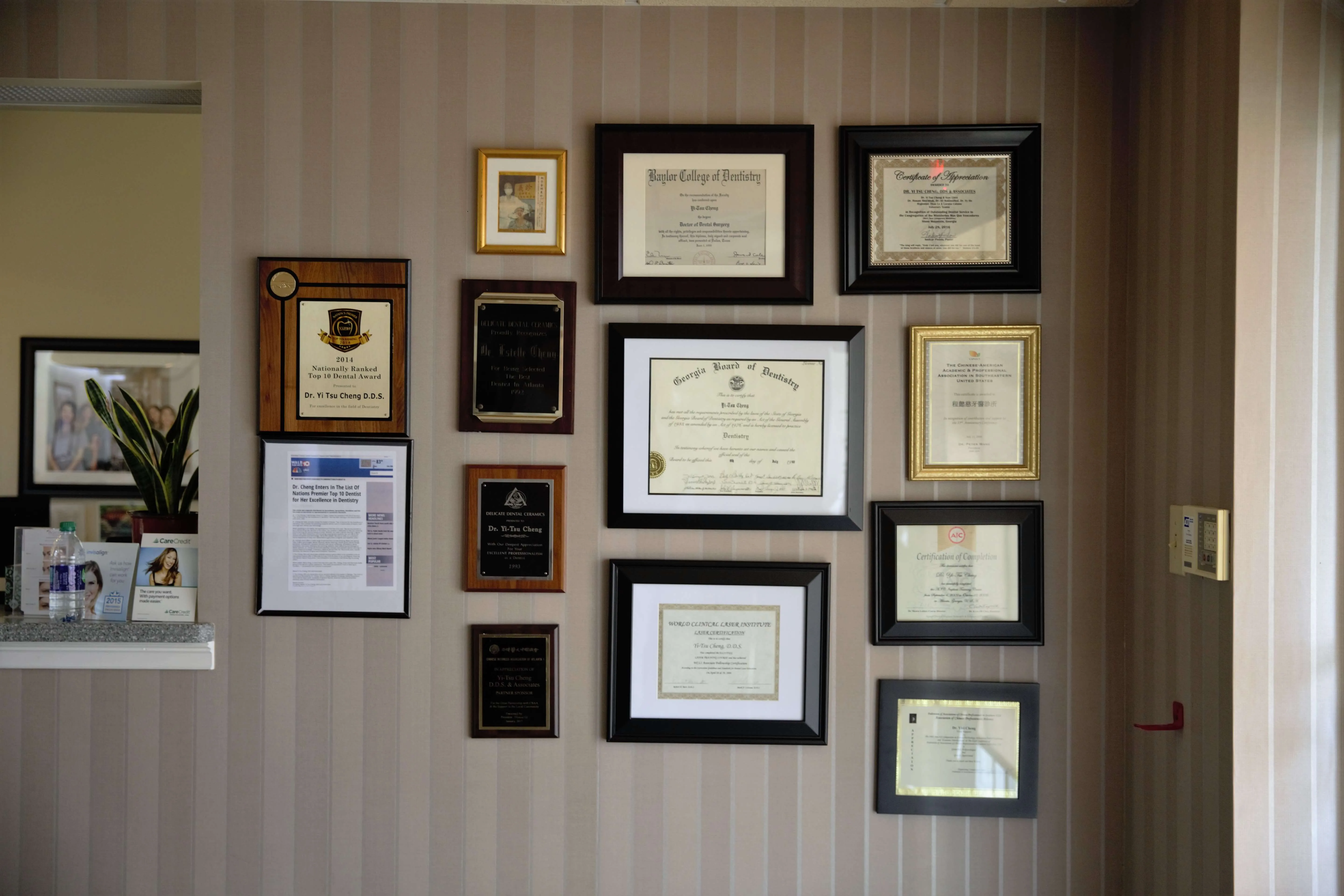 Credentials and awards wall at Yi-Tsu Cheng, D.D.S. & Associates in Chamblee, GA